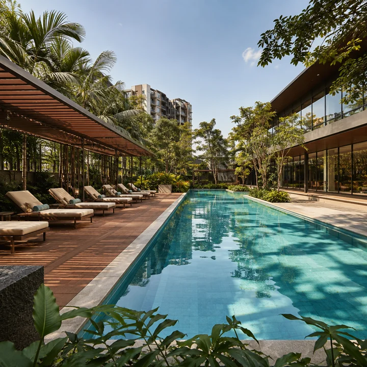 Embassy Sadahalli indicative lap pool with a timber sun deck and slatted pergola beside the glazed clubhouse wing